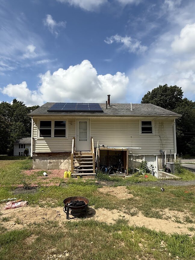 back view of outdated home at 90 Esta Rd before renovation