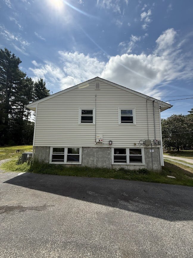 Side view of outdated home at 90 Esta Rd before renovation