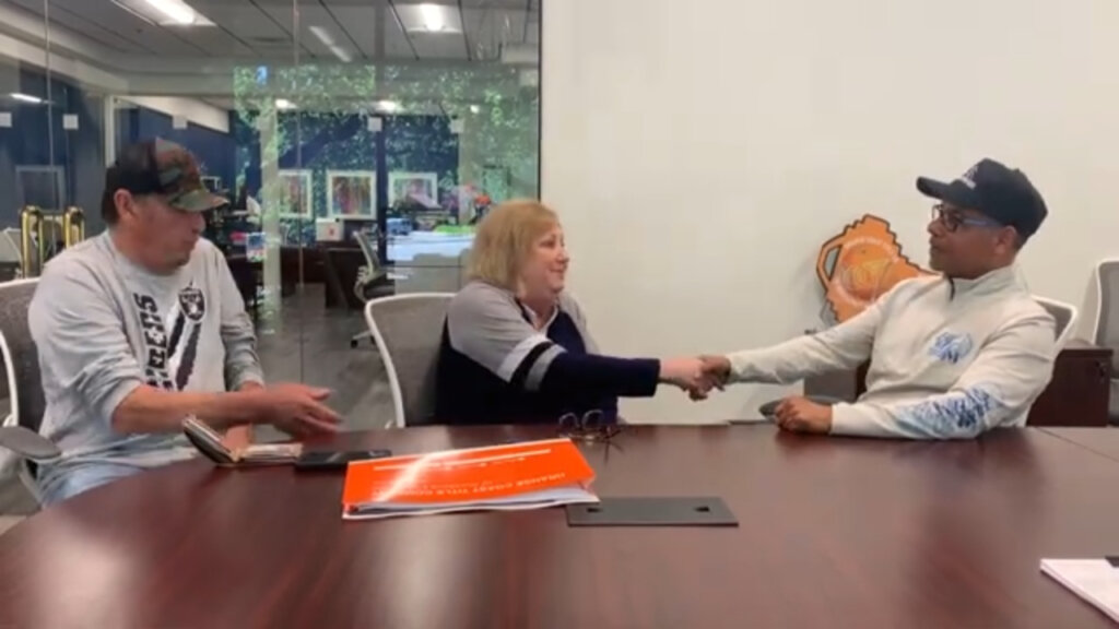 darren shaking hands with landlords who sold their home with tenants