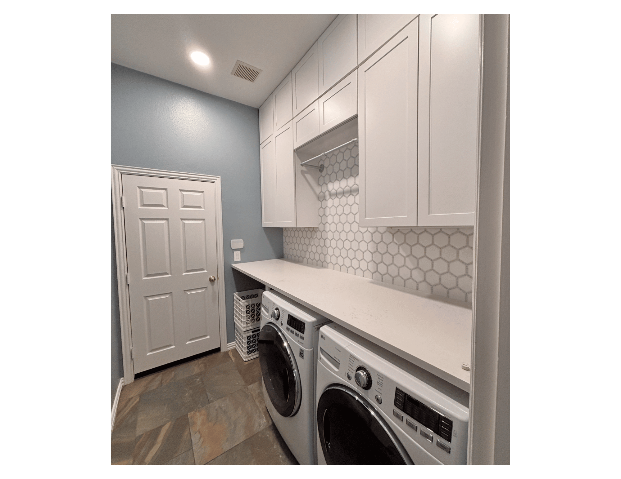 modern white laundry room remodel with floor to ceiling shaker cabinets