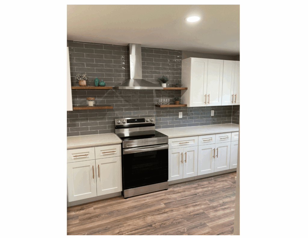 white and grey kitchen with quartz countertops and grey tile backsplash