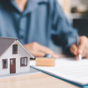 Buyer signing the final closing disclosure at the closing table
