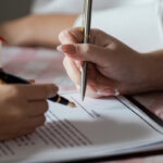 Buyer and agent reviewing a closing disclosure before settlement