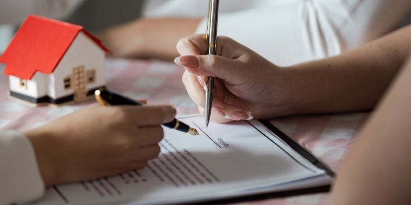 Buyer and agent reviewing a closing disclosure before settlement