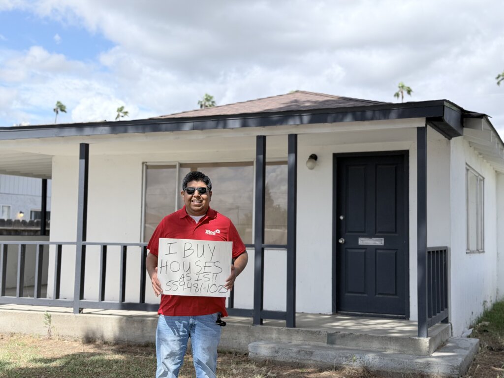 Person Holding a Sign that reads I Buy Houses As Is Fresno