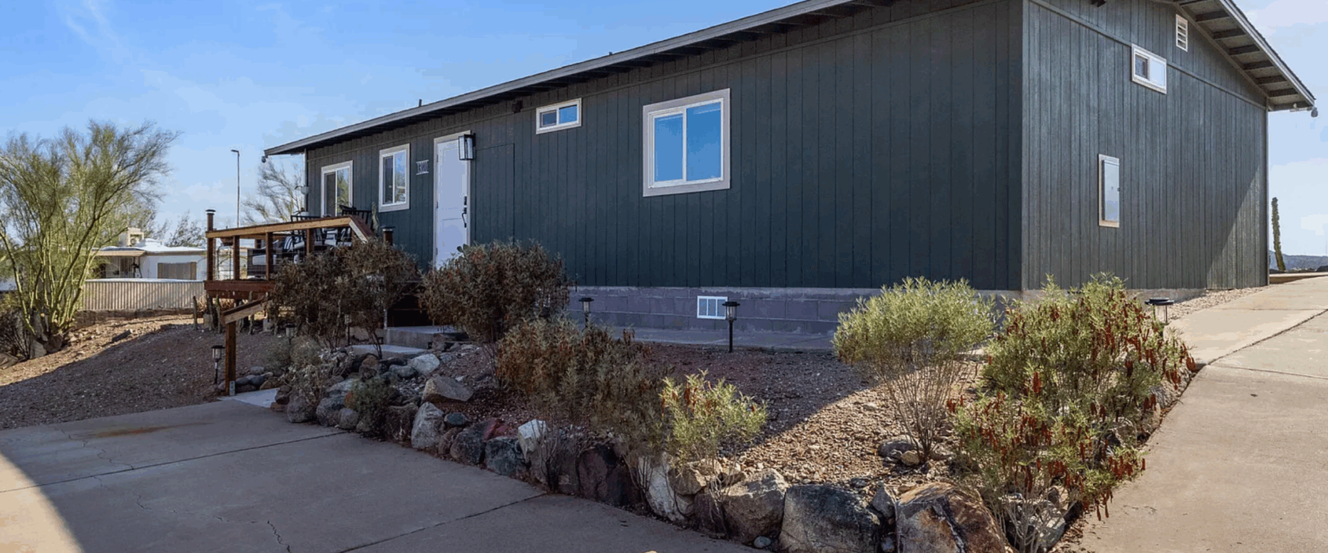 Manufactured home on large lot in Tucson with driveway and desert landscaping