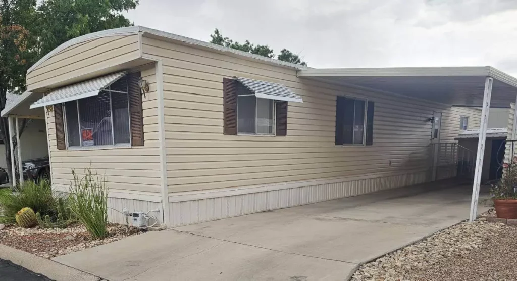 Single-wide mobile home with covered carport in a Tucson Arizona mobile home park
