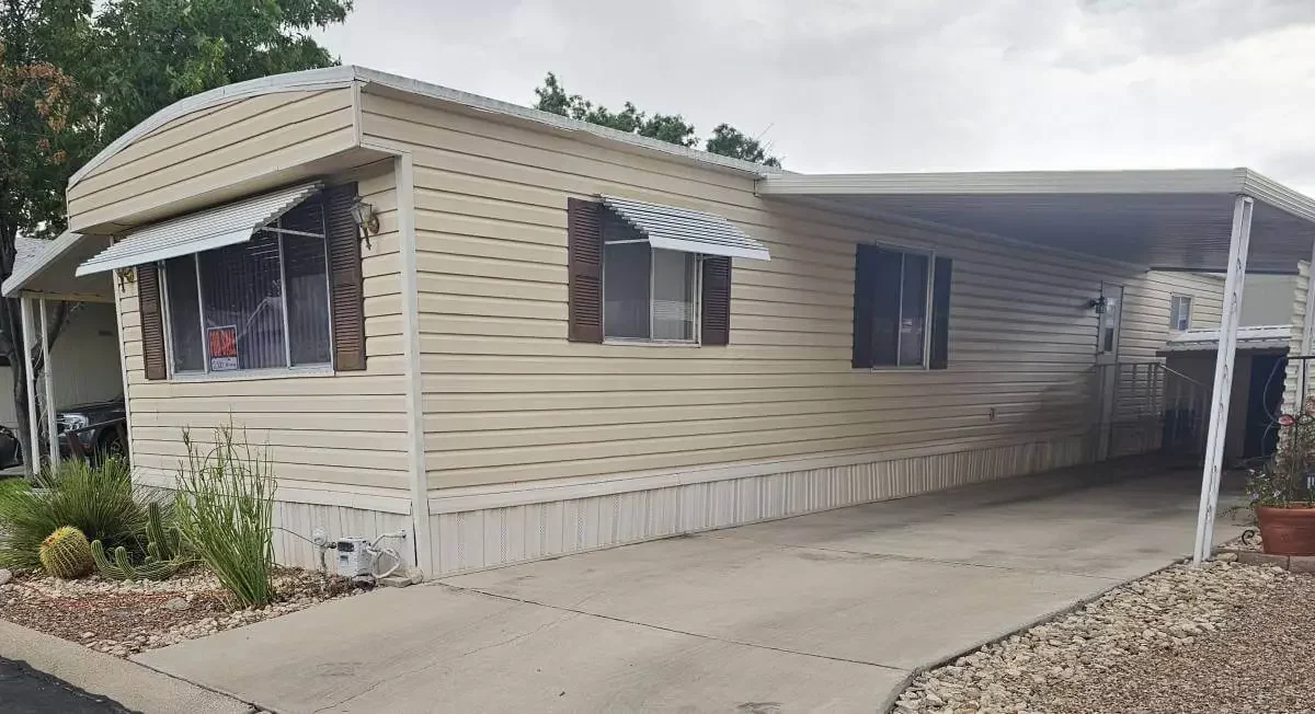 Single-wide mobile home with covered carport in a Tucson Arizona mobile home park