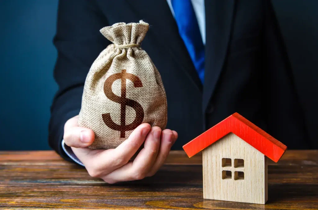 Homeowner reviewing an itemized New Jersey seller closing-cost estimate with a calculator.