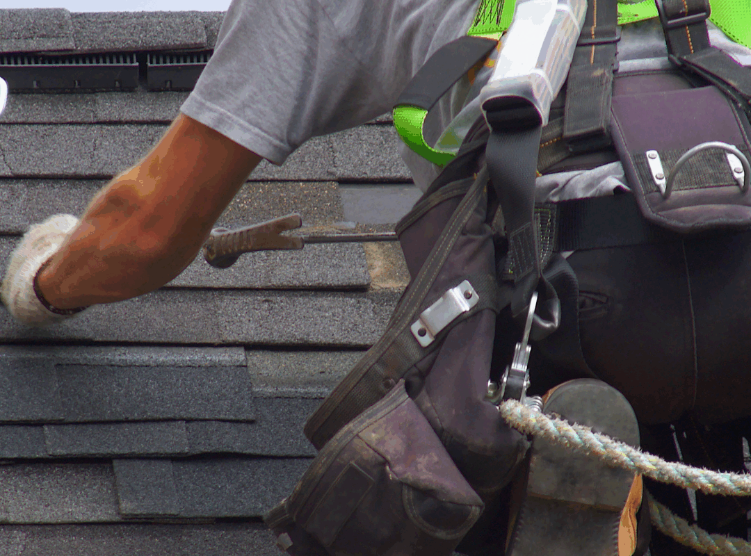 man maintaining a roof