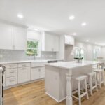 Modern kitchen renovation in Mandeville Louisiana with large island and shaker cabinets