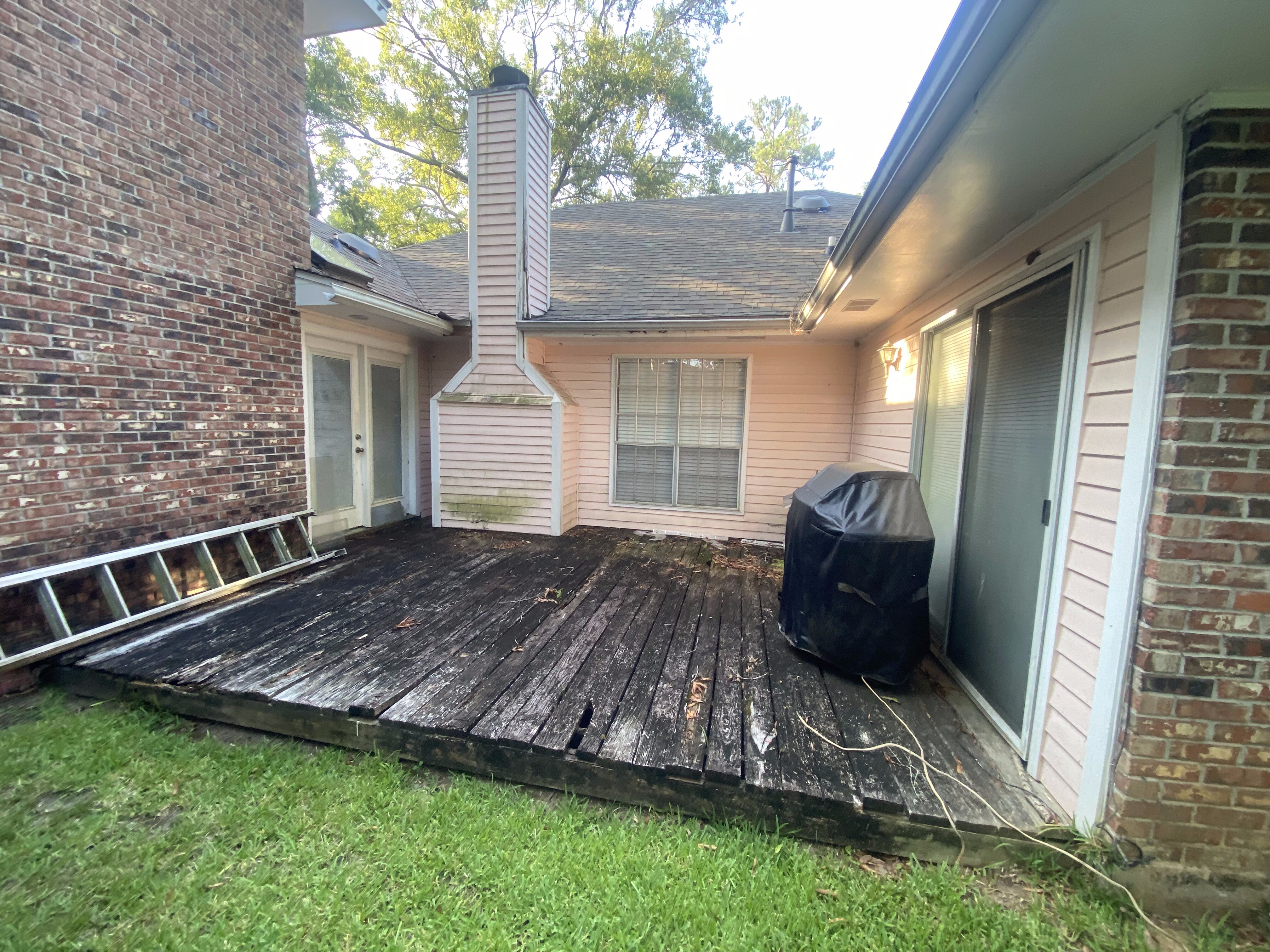 Worn deck before sunroom addition in Mandeville, LA