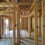 Open wall framing showing plumbing and electrical rough-in before drywall on a Northshore renovation