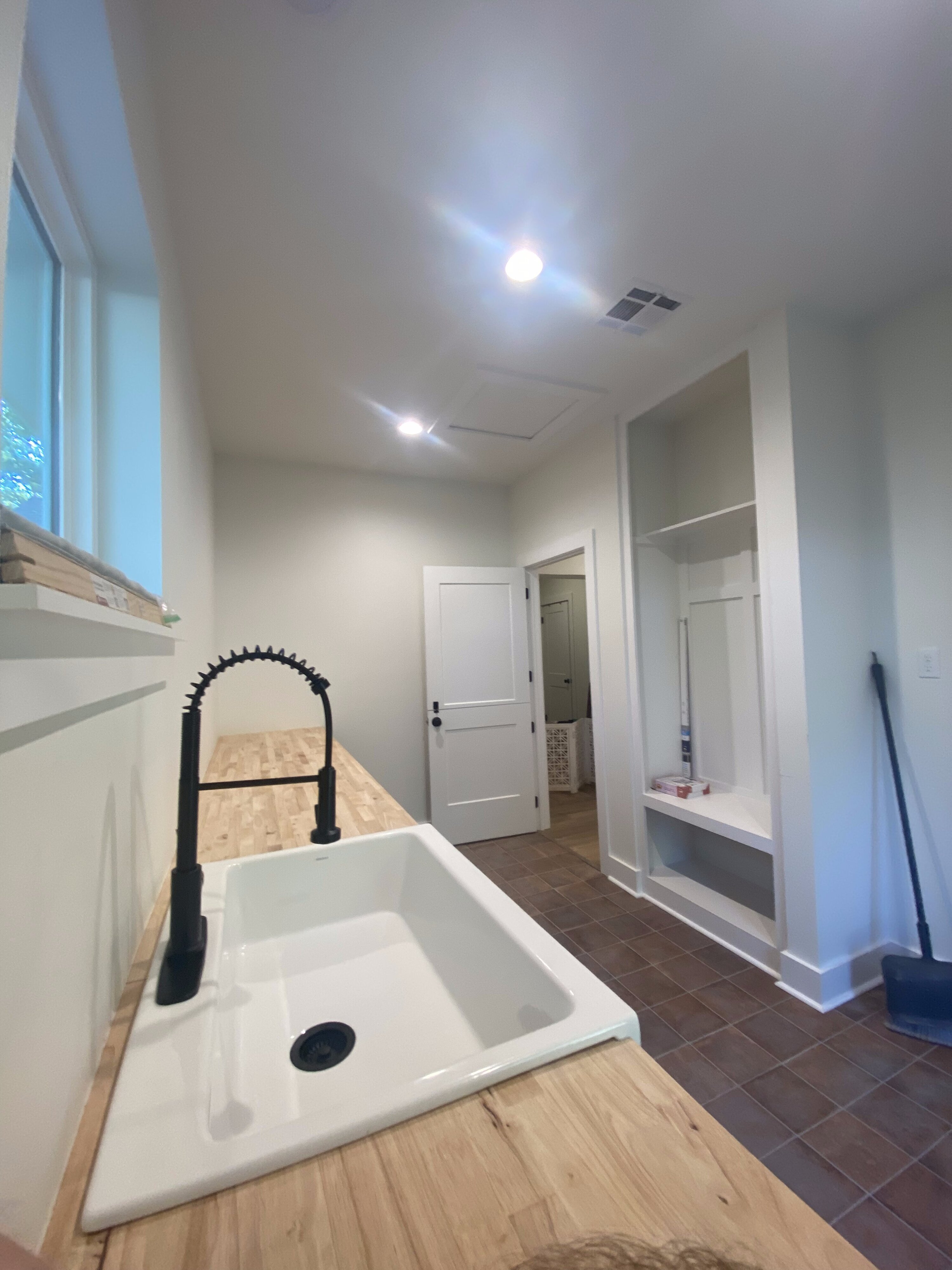 New laundry room with utility sink in Mandeville home addition