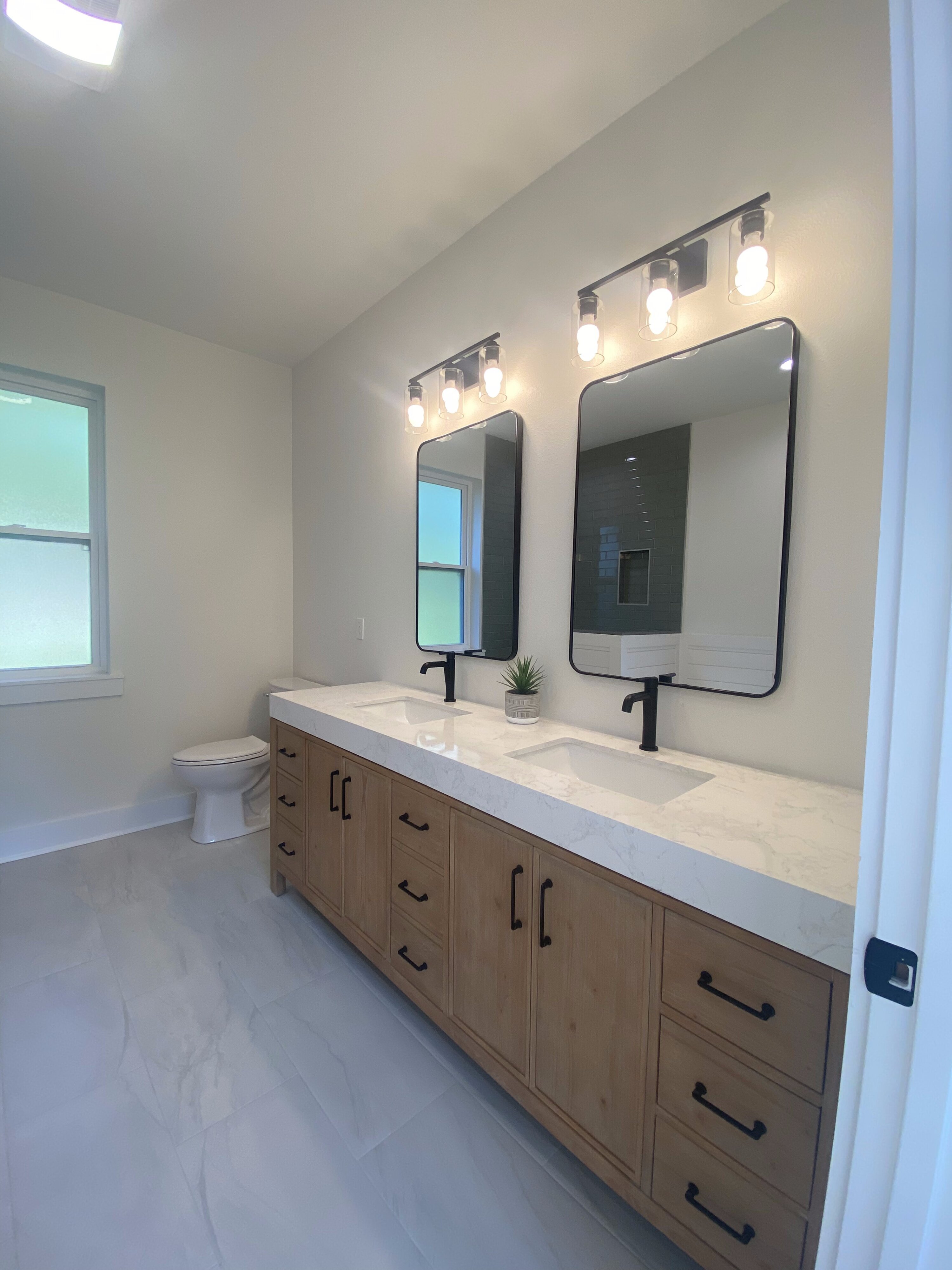 Primary bathroom double vanity with quartz countertop in Mandeville addition