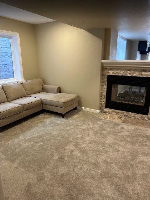 Remodeled basement seating area with a modern fireplace