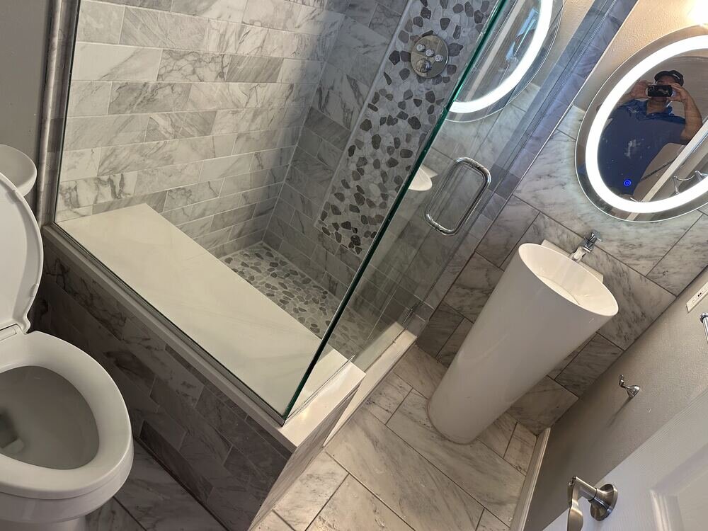 Dual-sink bathroom vanity with quartz countertop, completed remodel by The Build Squad