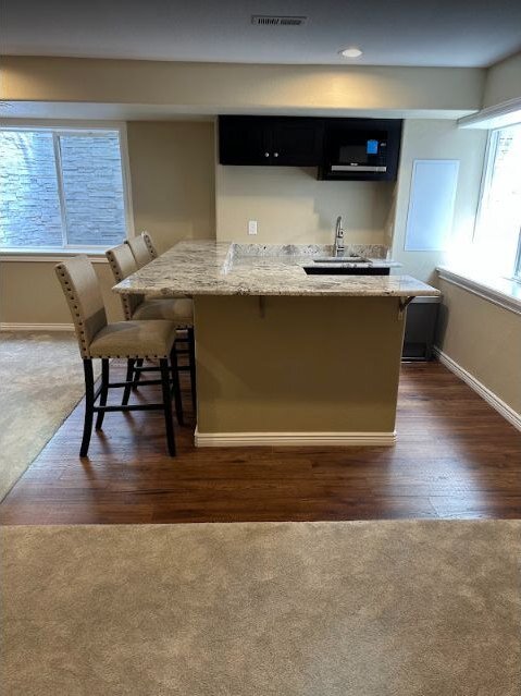 Remodeled kitchen with island seating and new flooring