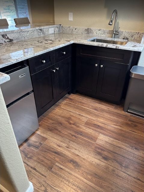 Kitchen renovation featuring updated cabinetry and wood-look flooring