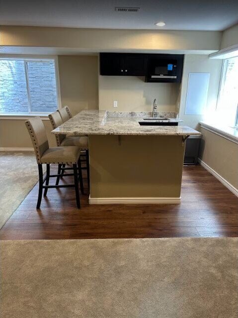 Remodeled kitchen with island seating and new flooring