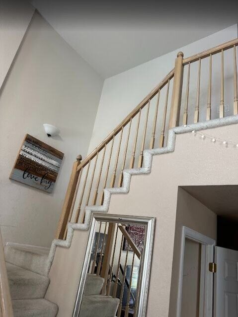 Remodeled staircase with new railing and finish work by The Build Squad