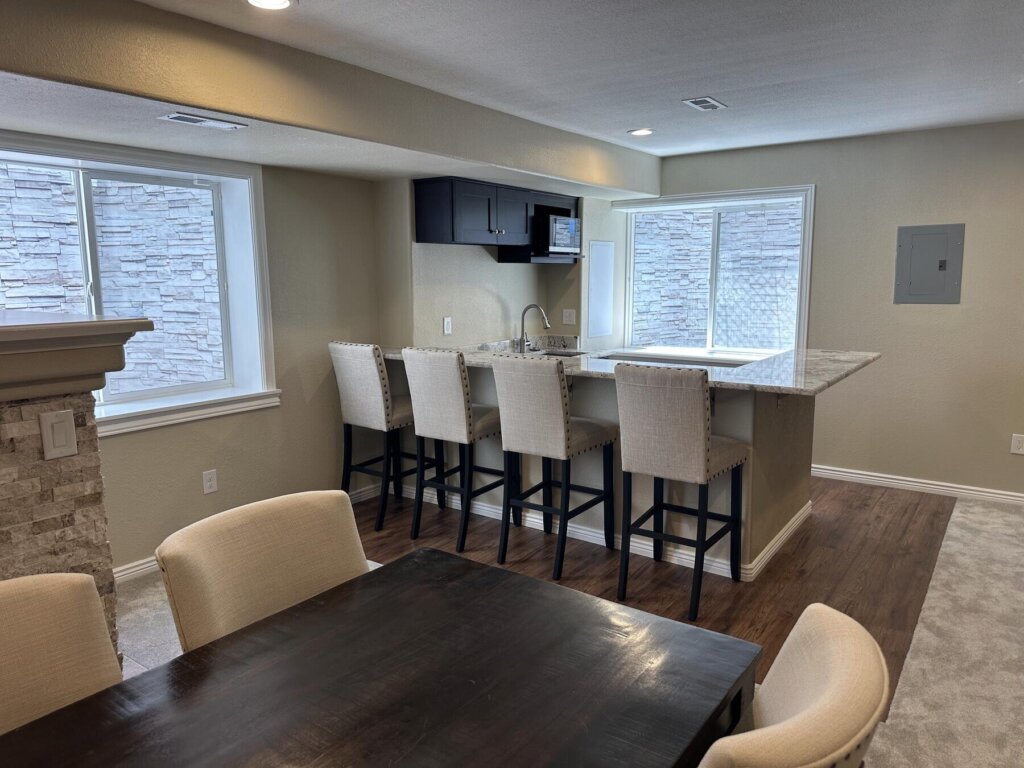 Finished basement wet bar and kitchenette with island seating