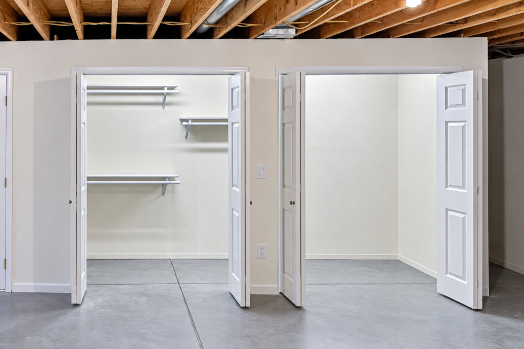 Finished basement with two new closets featuring wire shelving