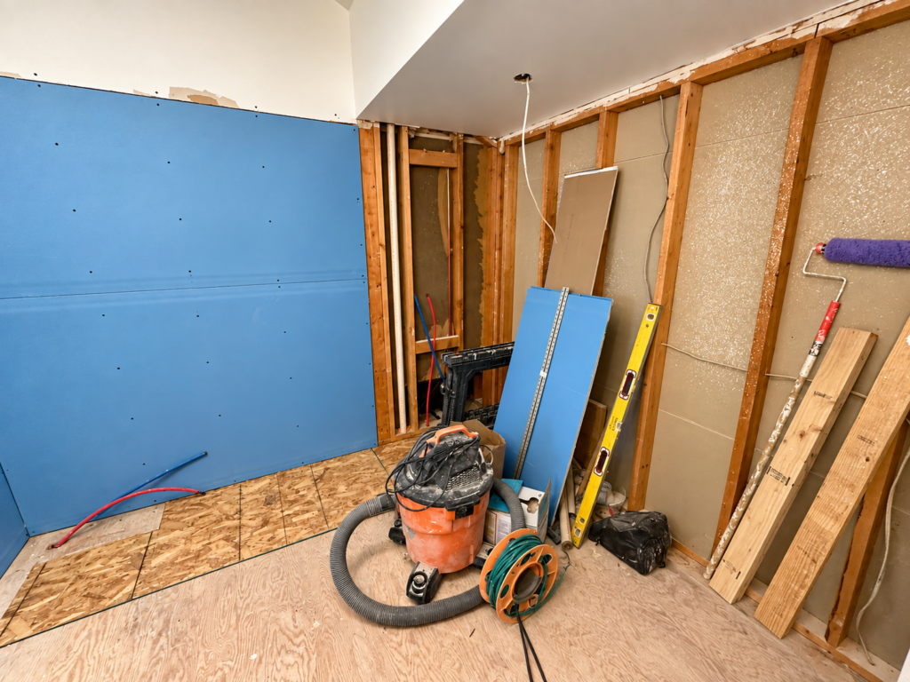 Bathroom renovation in progress with wall framing and drywall installation