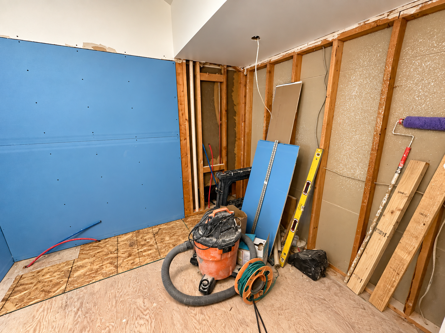 Bathroom renovation in progress with wall framing and drywall installation