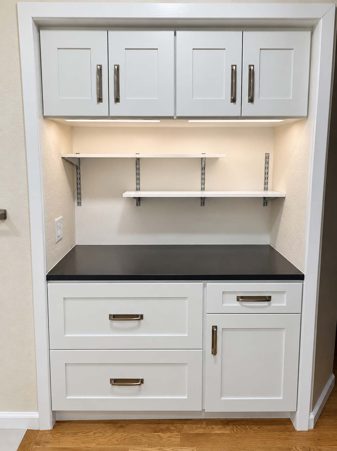 White built-in cabinetry with open shelving and dark countertop, front view