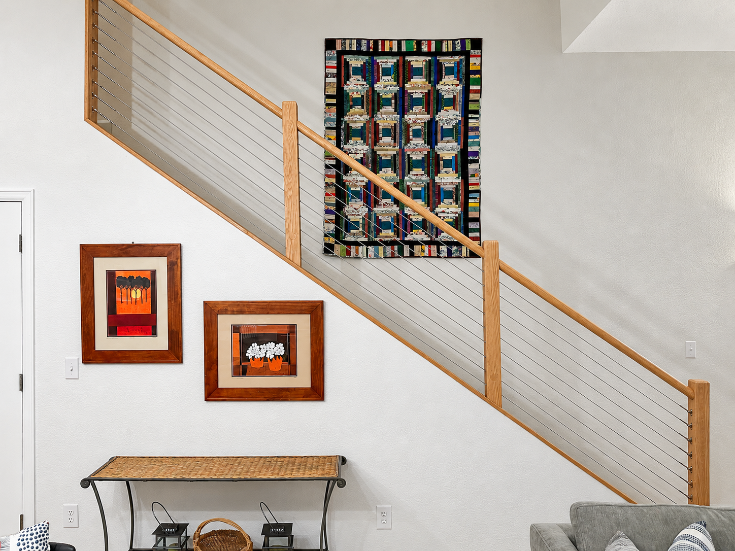 Wood and cable stair railing along an open staircase