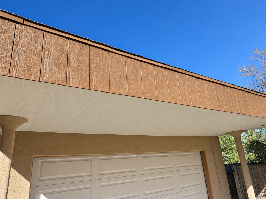New wood-look fascia and soffit above a garage exterior