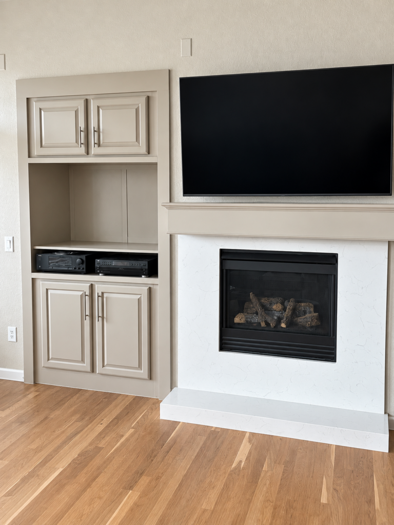 Living room with new fireplace surround and built-in cabinetry