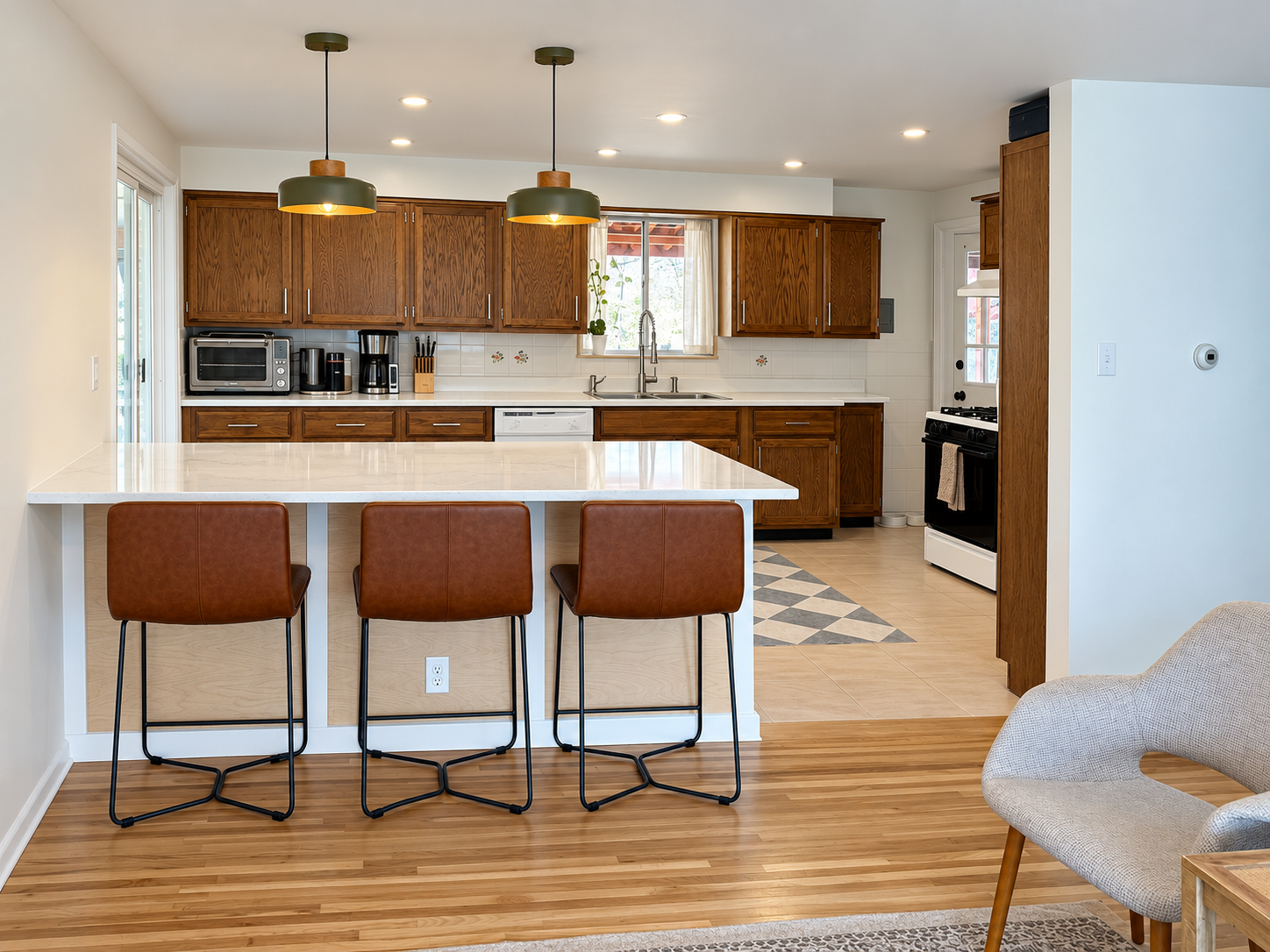 Kitchen with new waterfall-edge island and breakfast bar seating