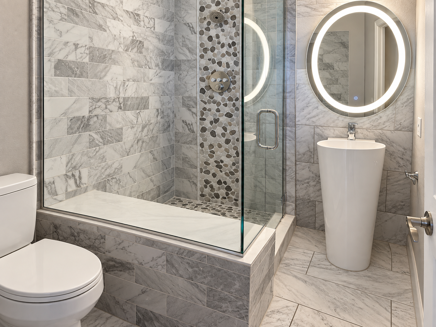 Bathroom with marble tile shower, pebble accent, and pedestal sink