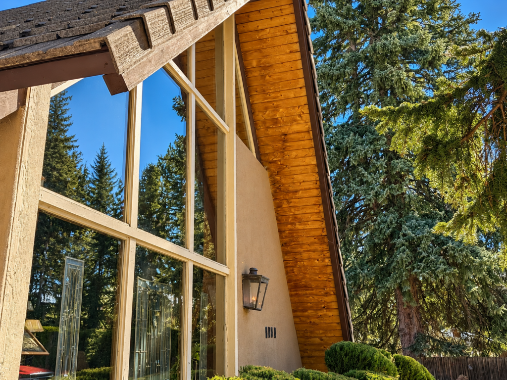 Exterior remodel by The Build Squad featuring a tall window with wood soffit detail