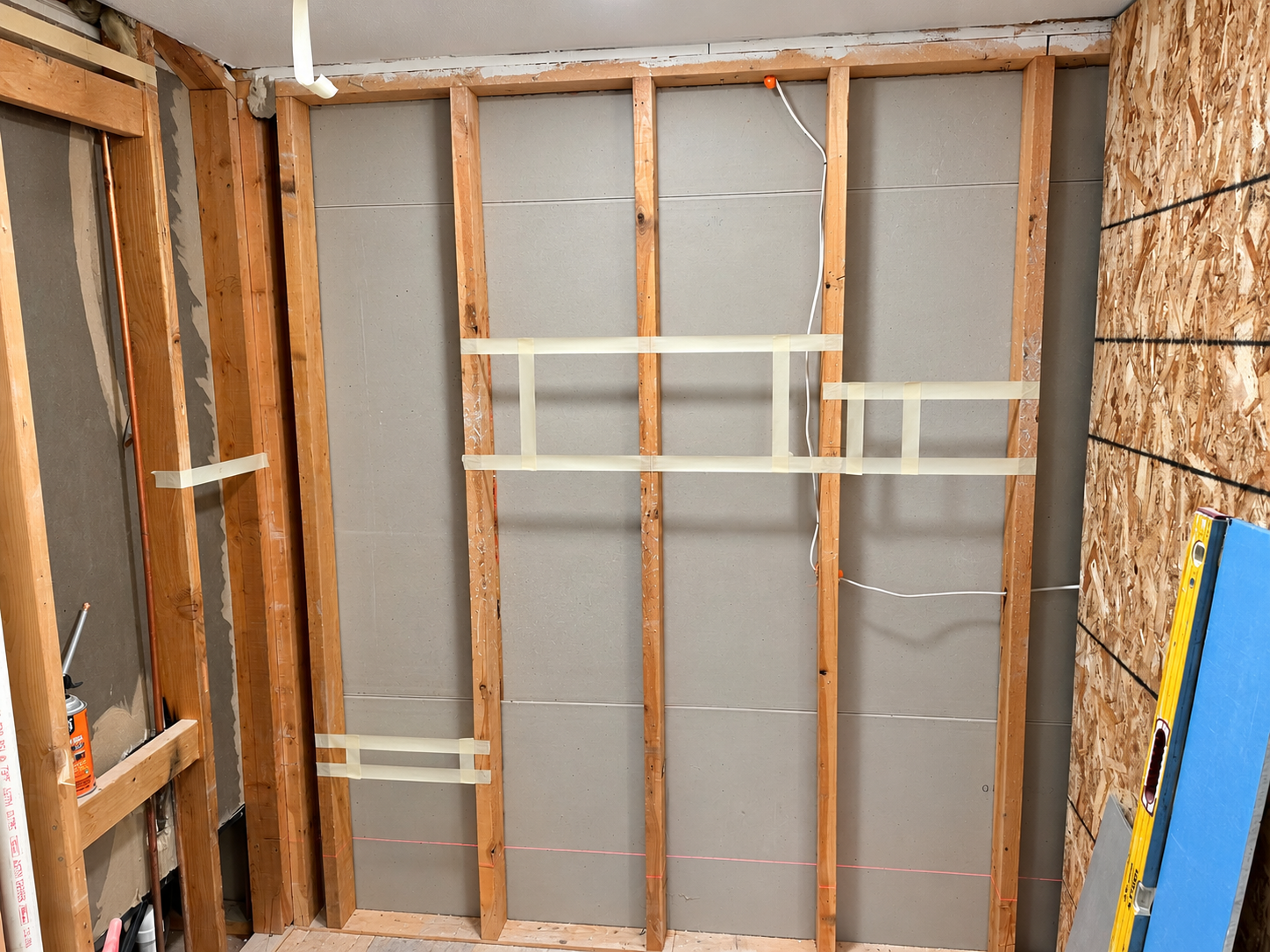 Interior wall framing with layout markings during renovation