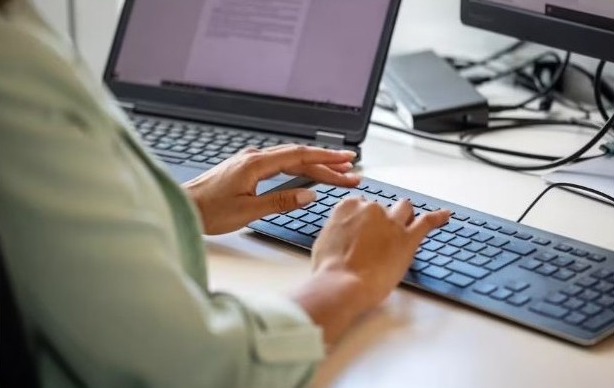 Person typing on computer