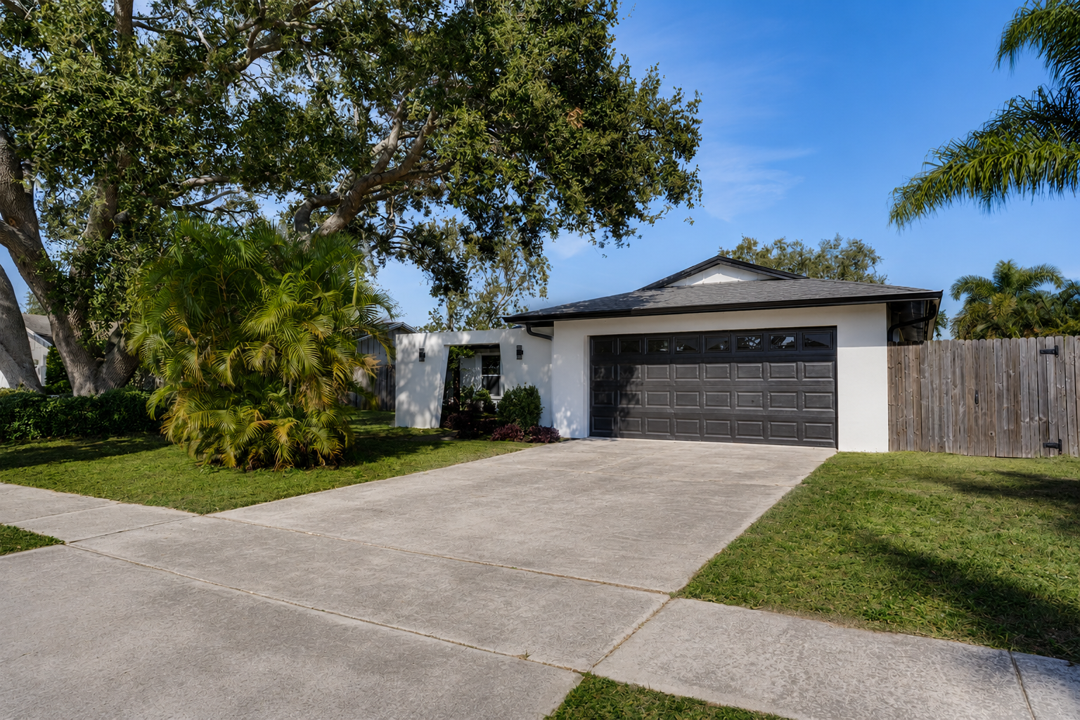 Off white stucco ranch with palm trees