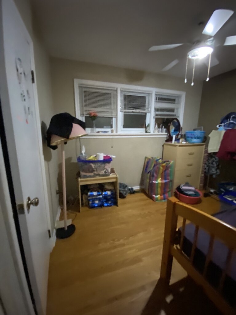 Cluttered interior room showing a home sold in its current condition