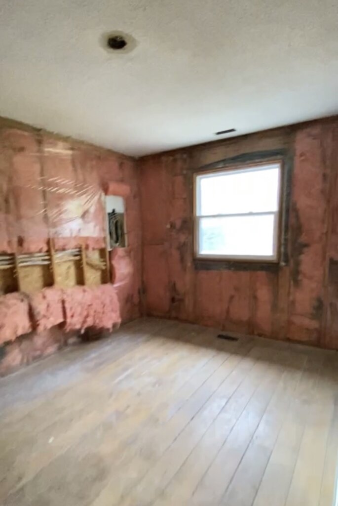 Unfinished room with exposed insulation and renovation in progress