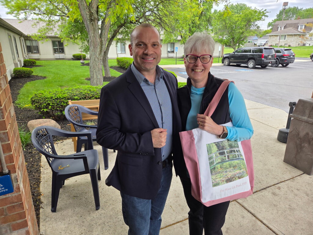 Dave Payerchin of Sell House Columbus standing with a happy Columbus Ohio homeowner after successfully selling their house for cash