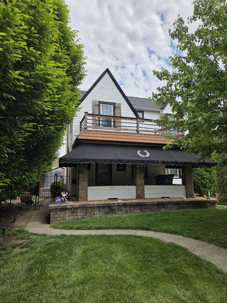 Residential home in Whitehall Ohio facing foreclosure with mortgage documents on a table