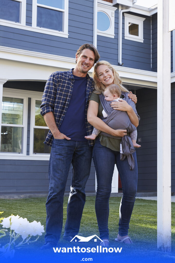 smiling family in front of a house