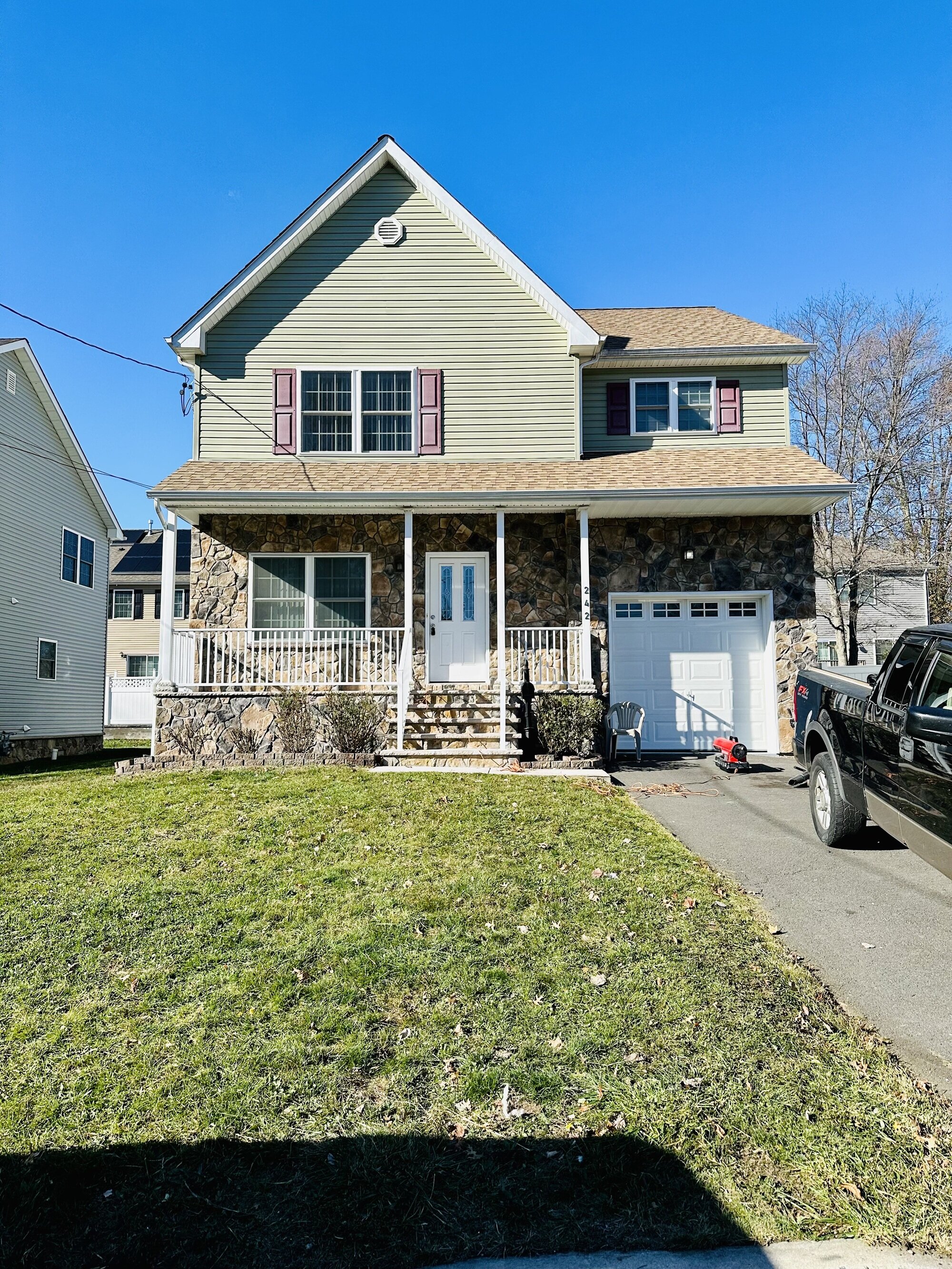 Two-story New Jersey house with a stone exterior and driveway