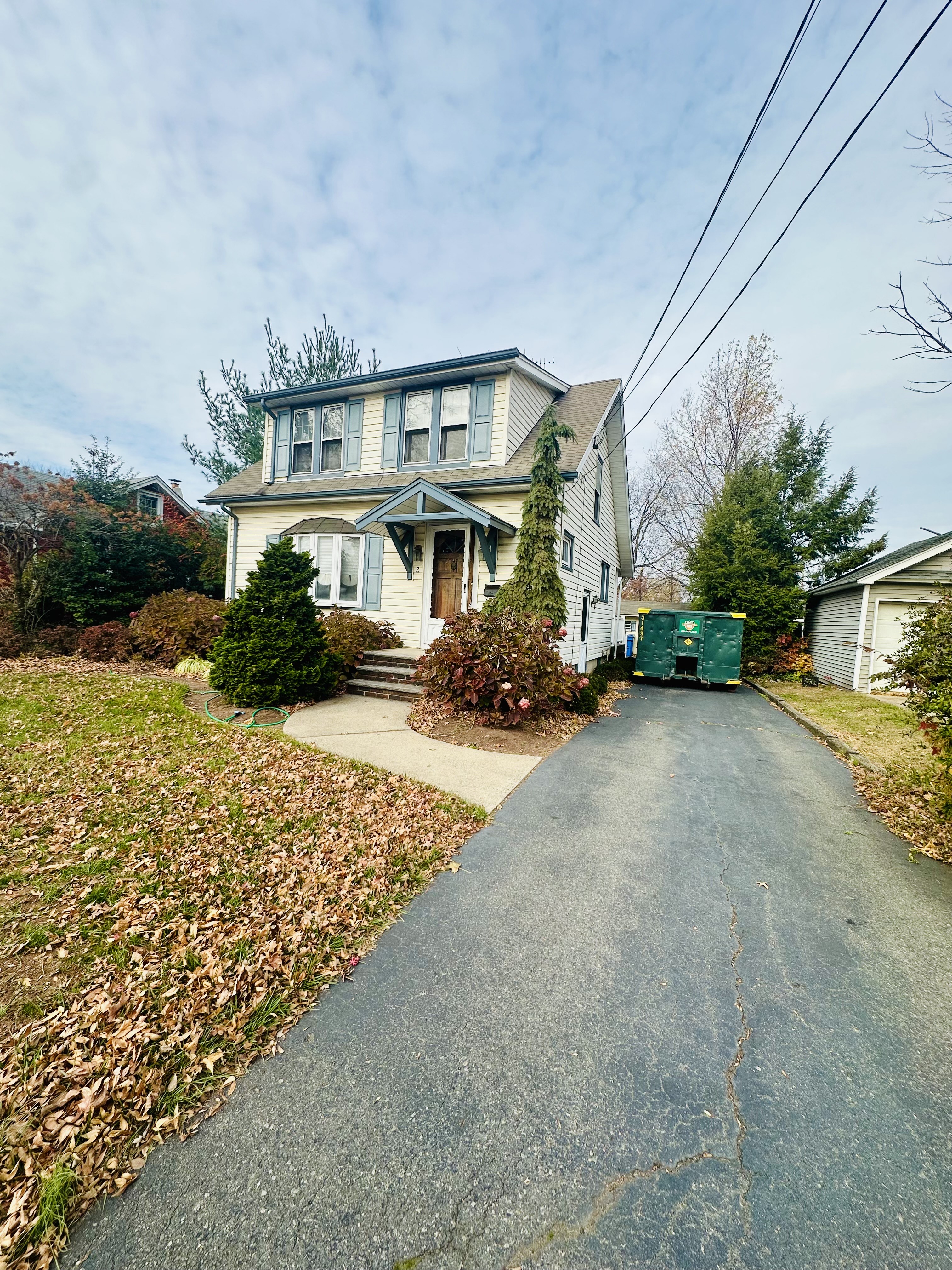 New Jersey house with a renovation dumpster beside the driveway