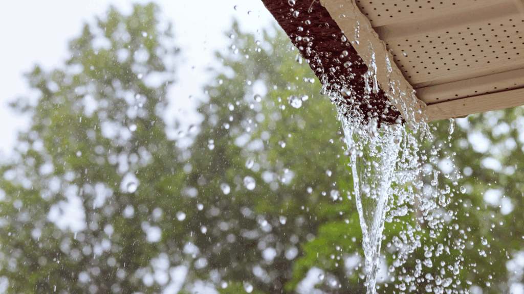 Overflowing gutters cause by heavy rains and clogged gutters and downspouts