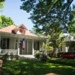 Front of a house in San Antonio, Texas with the Texas flag mounted off the front of the house