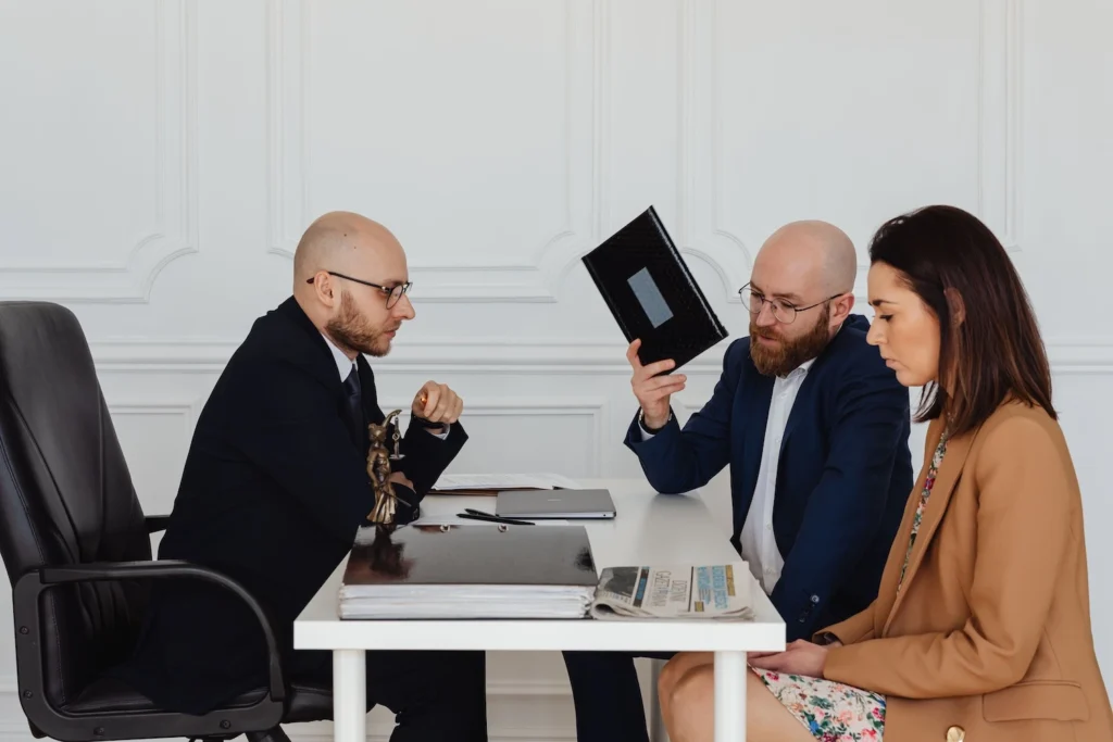 A couple sitting with a mediator at a white table