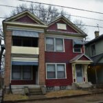 Red brick Michigan home blue shutters — sell house fast cash buyer Metro Detroit